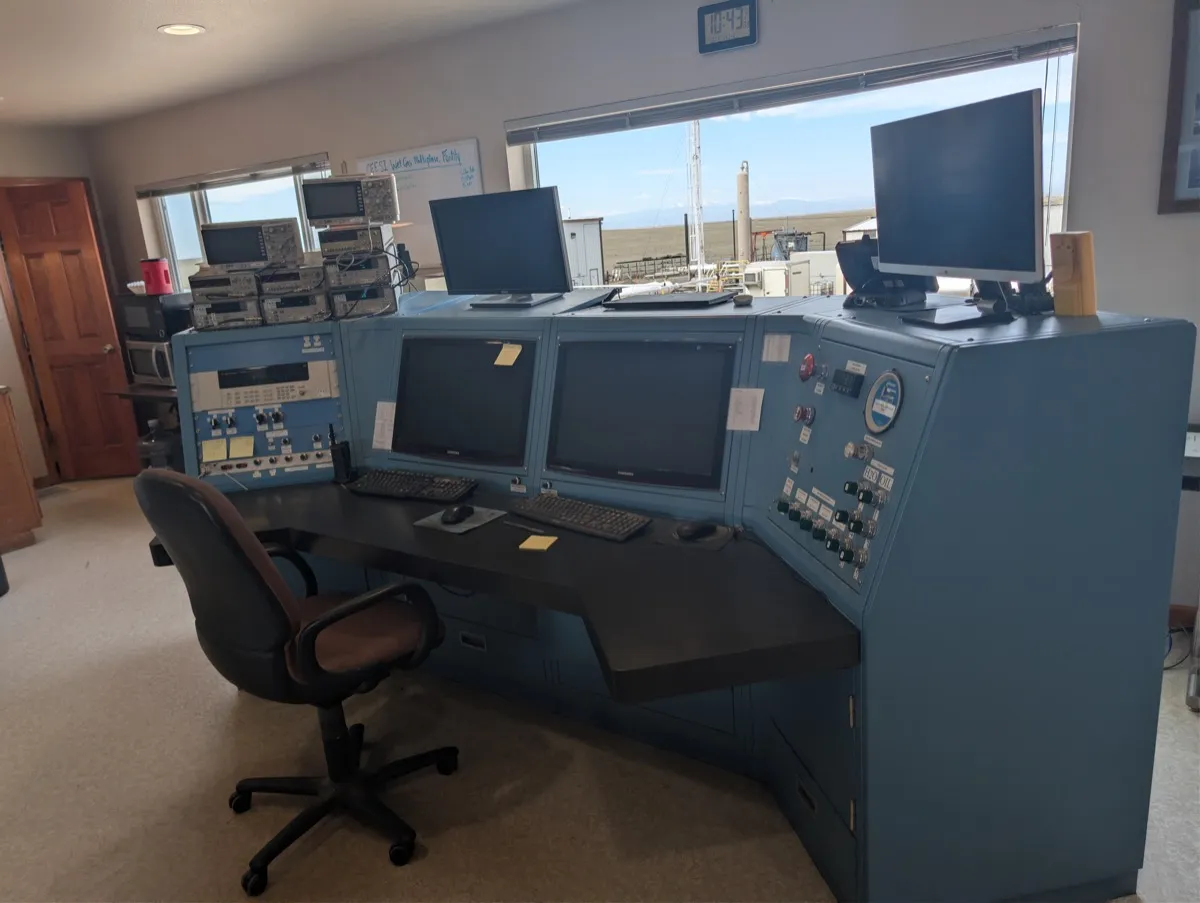 CEESI control room with data acquisition consoles and a view of the outdoor test facility