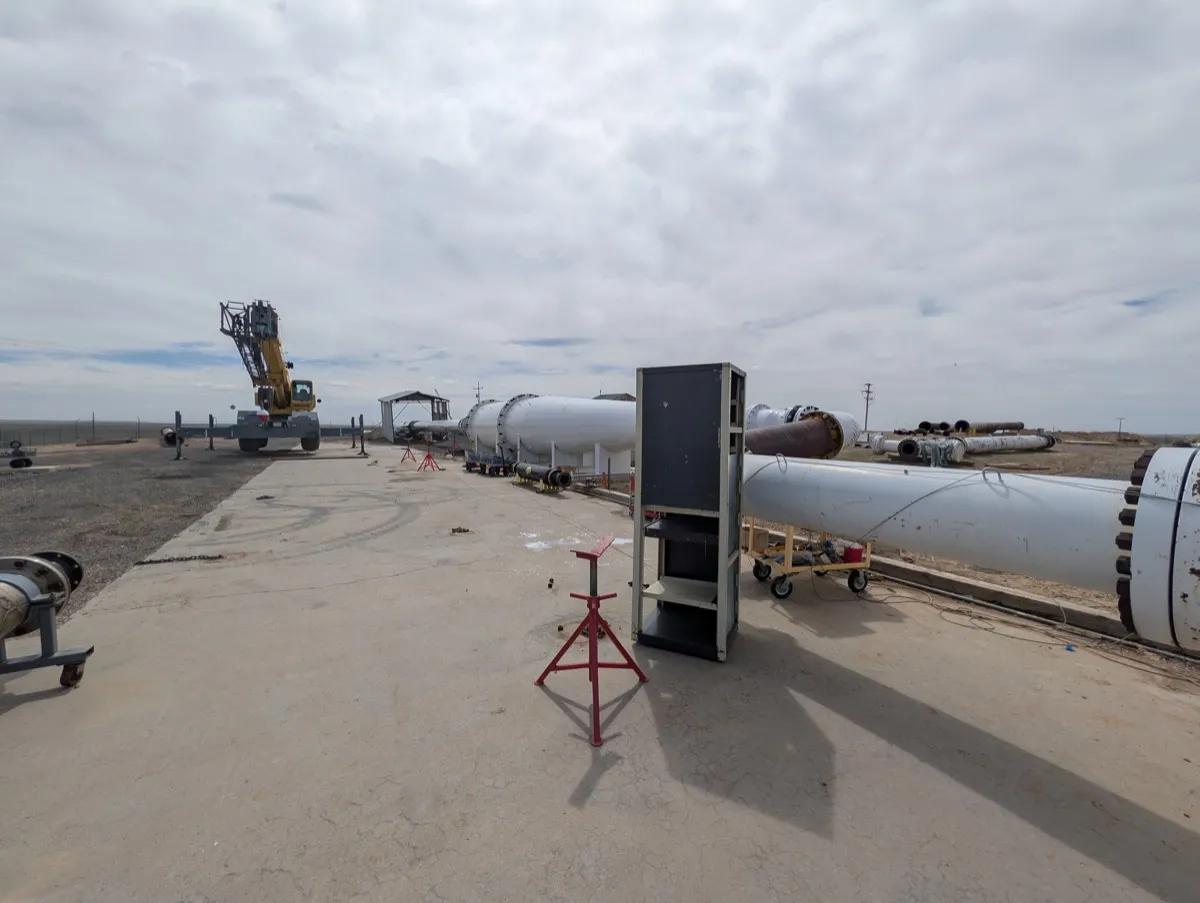Outdoor test pad at CEESI with large diameter pipe spools, meter runs and a mobile crane