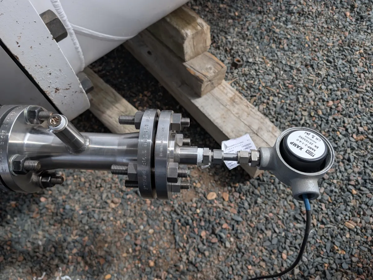 Ultrasonic transducer insertion mechanism on a 2-inch 150# duplex stainless flange with XAMP preamplifier, flange markings ASME B16.5 A182 F51 visible