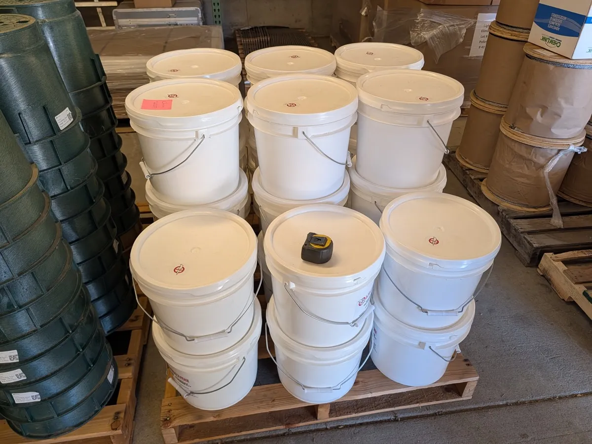Buckets of Chem-Rod refill kit for dry soil stacked on a pallet in the supplier warehouse